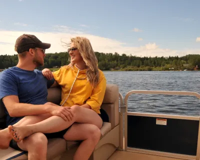 A couple cozy up on a boat on the lake in Athabasca