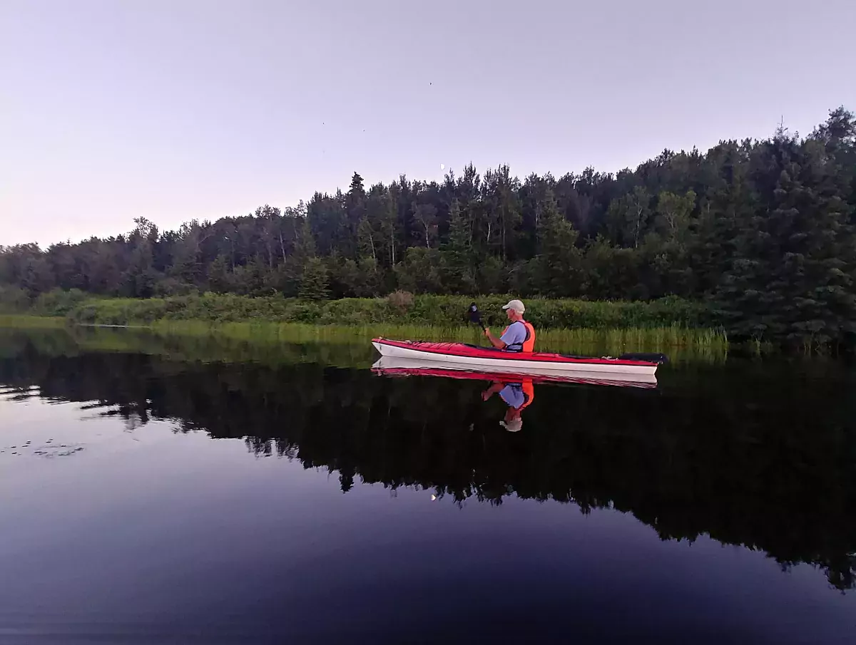 A man kayaking on a lake in Vermilion