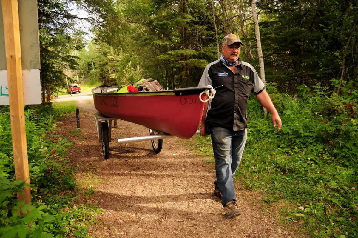 Carrying a canoe to the lake in Lac La Biche